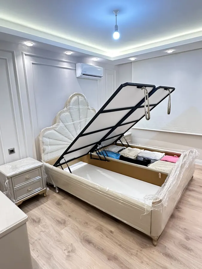 Classic bed with the base raised, showing the storage volume