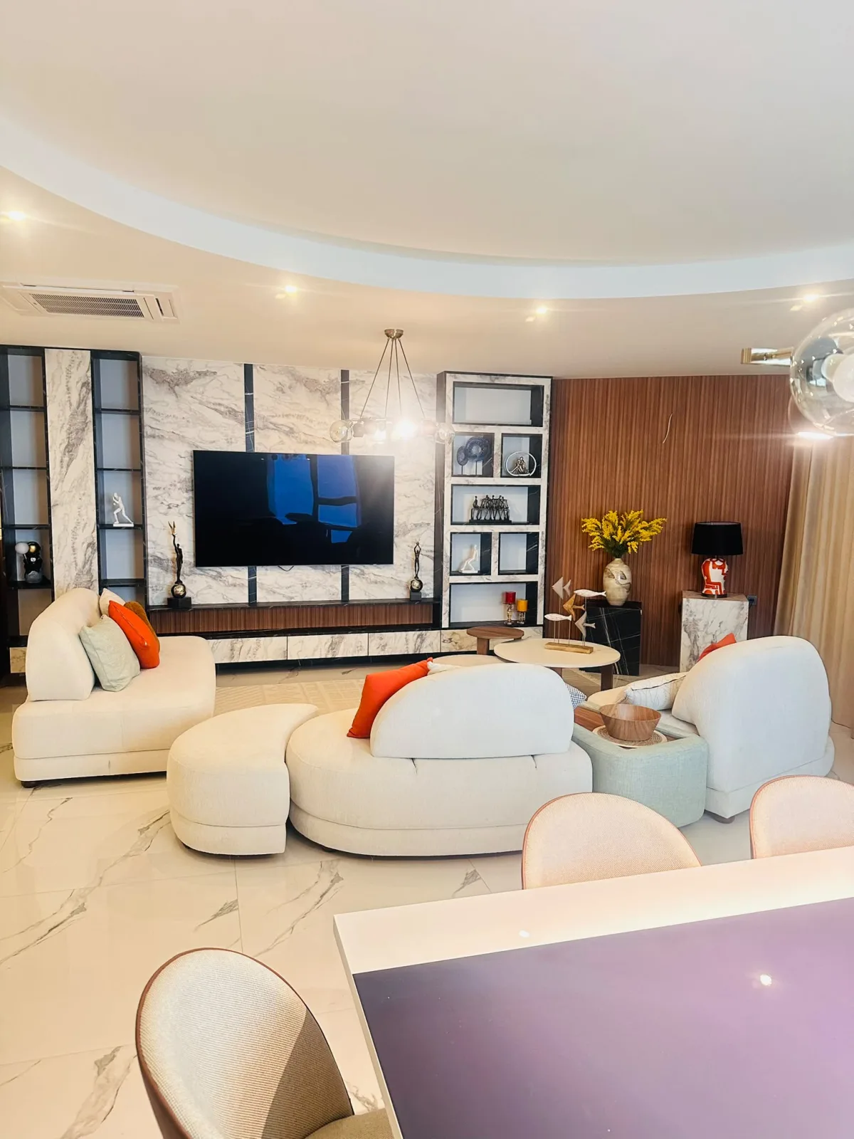 Panoramic living room with marble TV wall and seating group