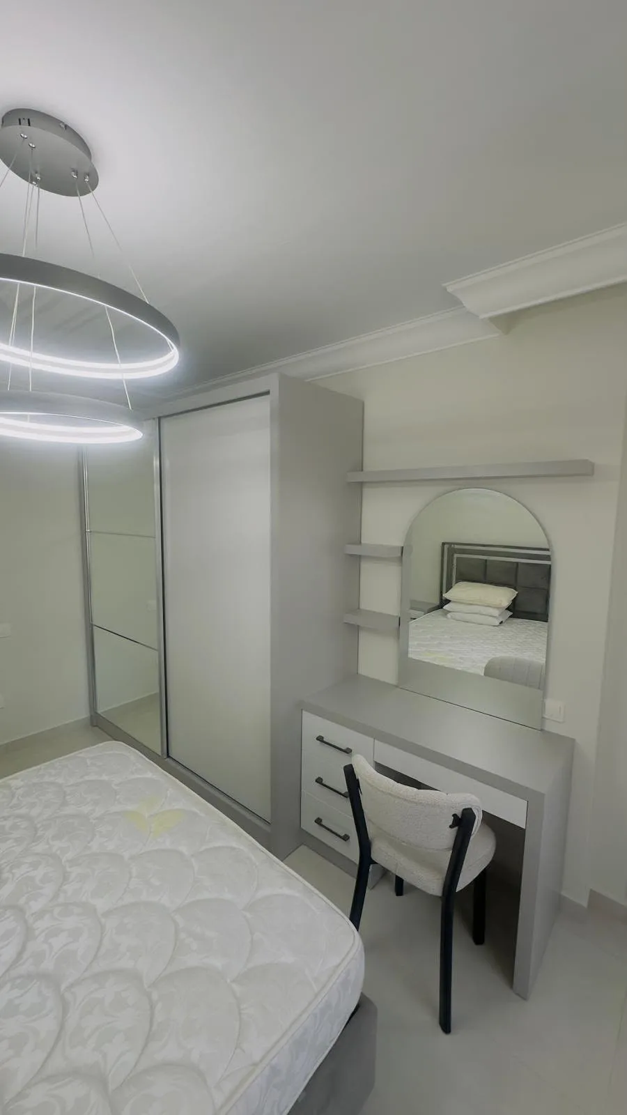 Mirrored sliding wardrobe with vanity unit